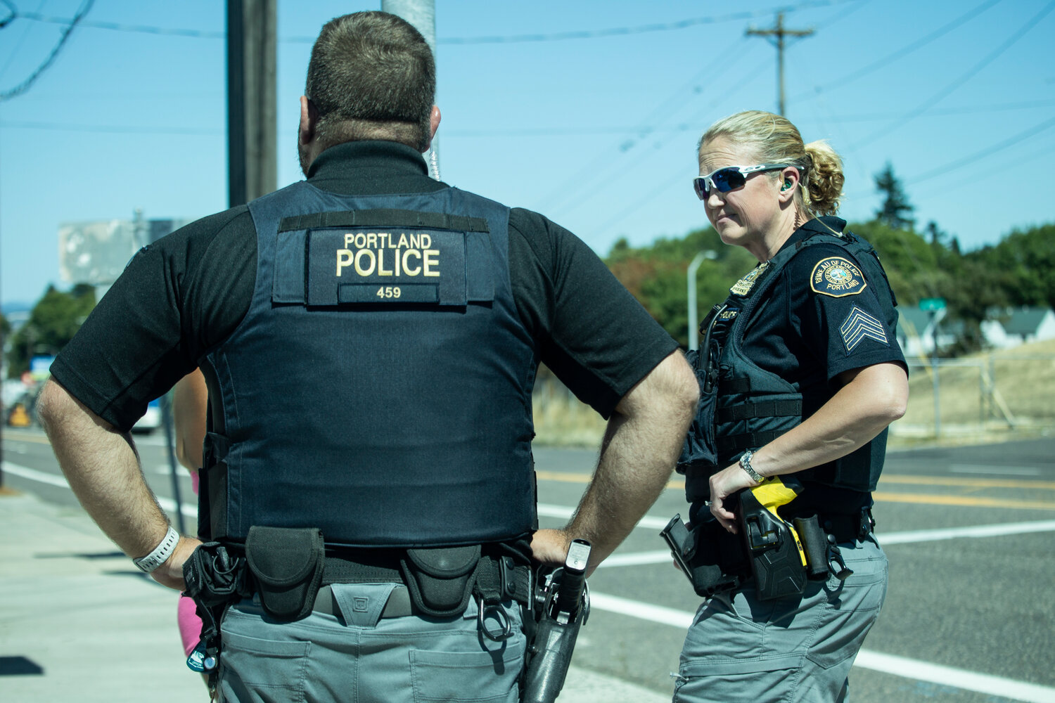 Detective Tim Larsen and Sgt. Kristi Butcher, members of the Portland Police Bureau’s Human Trafficking Unit, gather information from an adult who they suspect is a victim of sex trafficking during a directed patrol mission in July. Larsen and Butcher say many adult trafficking victims were first trafficked as minors. (Moriah Ratner/InvestigateWest)